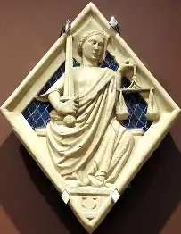 Glazed relief of Justice, a crowned woman holding a sword and scales